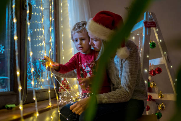 istock Young mother drawing with her boy on the window 1445672460