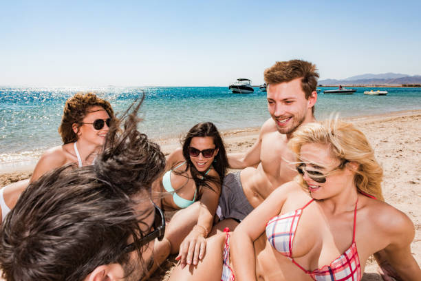 istock Happy friends talking during summer day on the beach. 1445672673