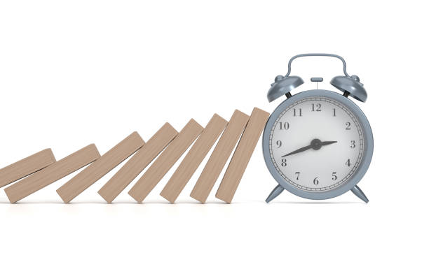 istock Alarm Clock stopping wooden domino 1445673848