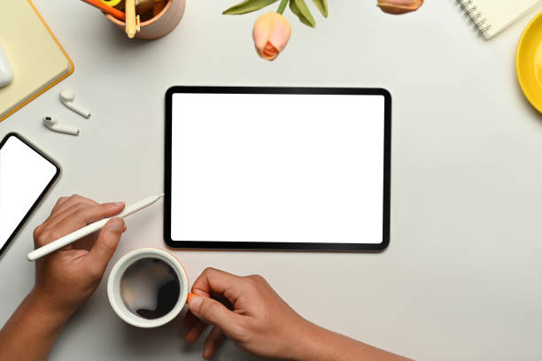 istock Digital tablet, smart phone, stylus pen and cup of coffee on white background. Empty screen for advertise design. 1445675417