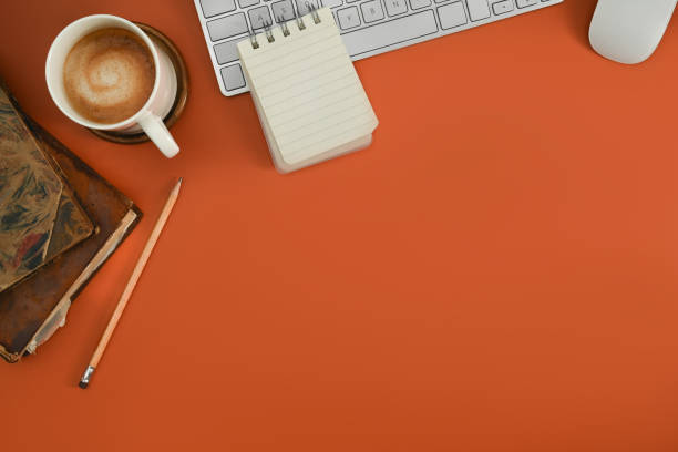 istock Top view of creative workspace with wireless keyboard, coffee cup and notepad. Copy space for your text. 1445675469