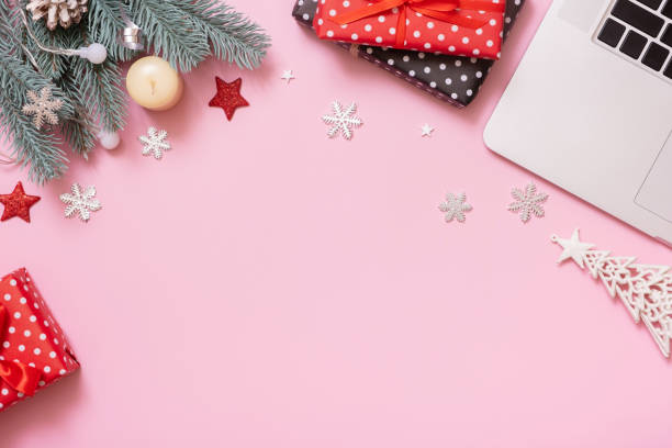 istock Christmas New Year decoration on work table with laptop, copy space, top view, flat lay on pink background 1445676092