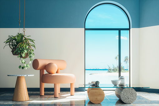 Mid-century modern living room with coral colored curvy furniture and tropical ocean view.