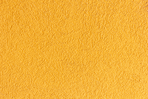 Yellow wall texture. Warm color wall background.