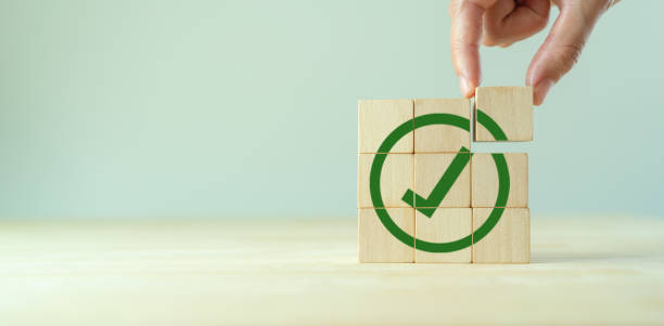 istock Corporate regulatory and compliance. Goals achievement and business success. Task completion. Ethical corporate. Do the right thing. Quality and ISO symbol. Wooden cube with green checkmark icon. 1445683095