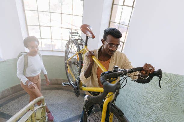 istock Student bringing his bike back to a dorm room 1445687744