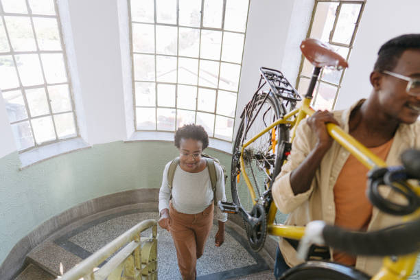 istock Student bringing his bike back to a dorm room 1445687773