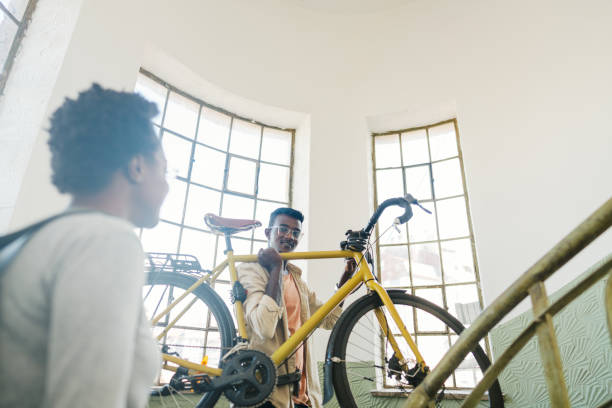 istock Student bringing his bike back to a dorm room 1445687776