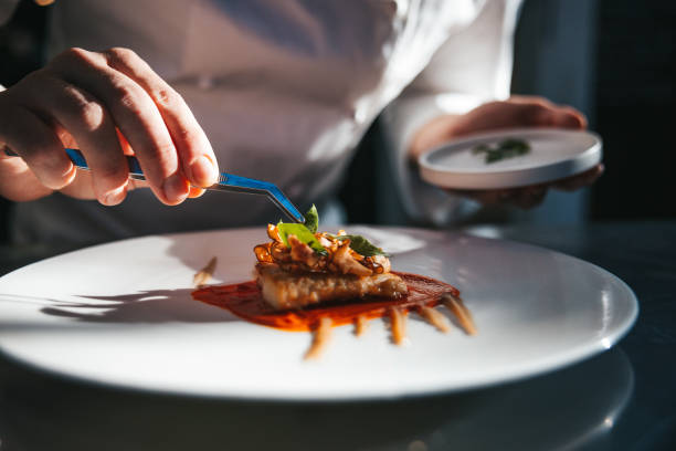 istock Chef preparing a gilthead bream dish in a luxury restaurant 1445690528