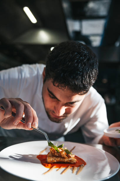 istock Chef preparing a gilthead bream dish in a luxury restaurant 1445690667