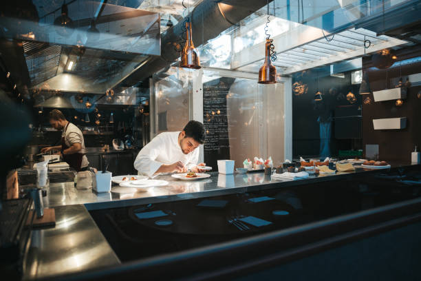 Chef preparing a plate in a gourmet restaurant stock photo