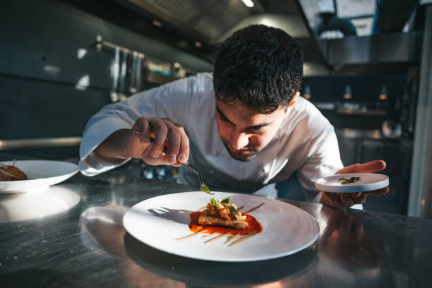 istock Chef preparing a gilthead bream dish in a luxury restaurant 1445691794