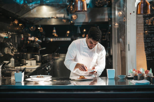 istock Chef preparing a plate in a gourmet restaurant 1445691843