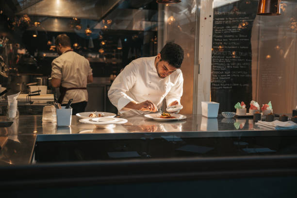 istock Chef preparing a plate in a gourmet restaurant 1445692268