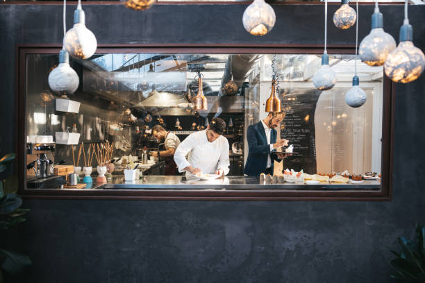 Young chef plating and finalizing food in a fine dining luxury restaurant