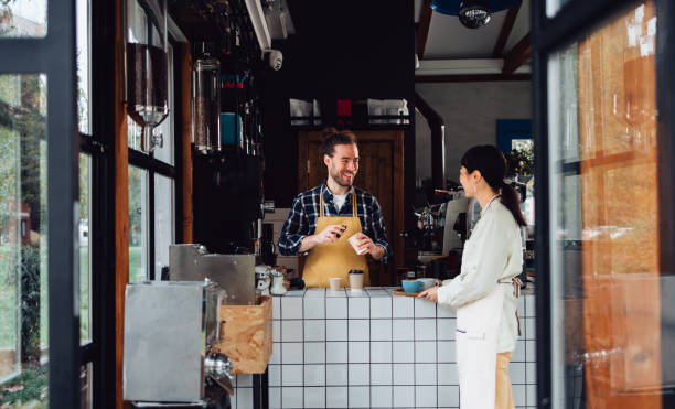 istock Two Happy Colleagues Working Together In A Coffee Shop 1445692363