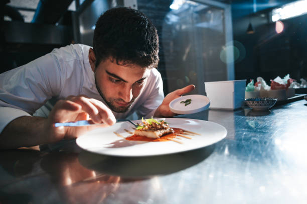 istock Chef preparing a gilthead bream dish in a luxury restaurant 1445693214