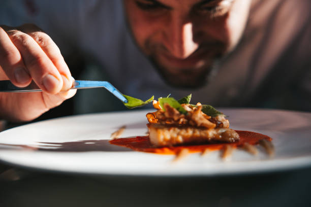 istock Chef preparing a gilthead bream dish in a luxury restaurant 1445693379