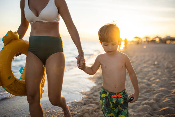 istock Mother and son on a walk on the beach 1445693494