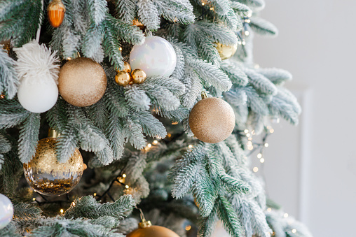 Christmas decoration on an abstract background. Festively decorated Christmas tree. Happy New Year. Soft selective focus, copy space.