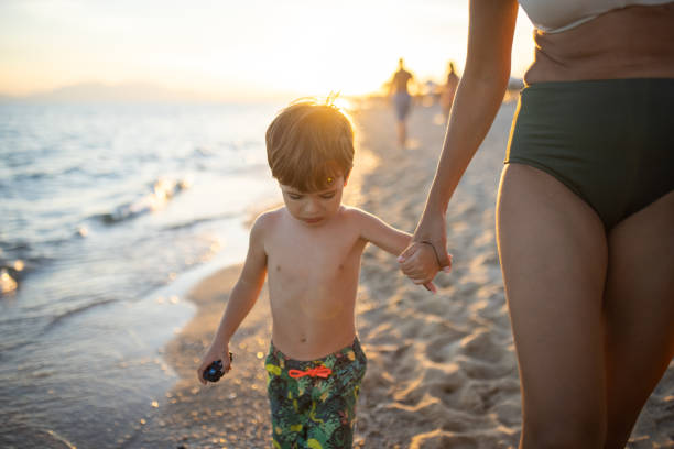 istock Mother and son on a walk on the beach 1445694606
