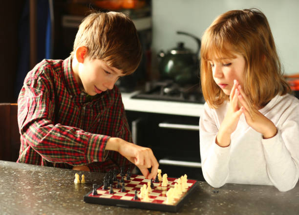 istock Children playing chess at home kitchen 1445694919