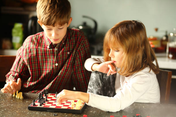 istock Children playing chess at home kitchen 1445694933