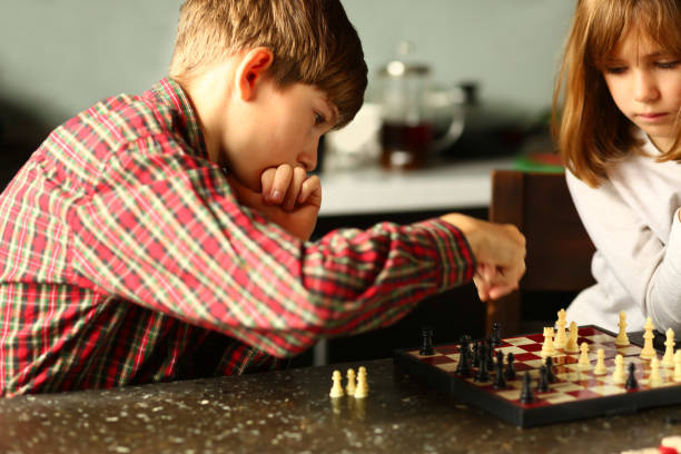 istock Children playing chess at home kitchen 1445695330