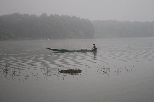 boat in the middle of the river with a fisherman