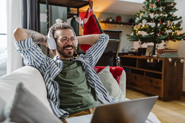 istock A young man lying on the sofa and consuming internet content 1445696742