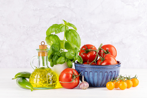 Ingredients for cooking. Italian cuisine. Tomatoes, olive oil, basil. With copy space