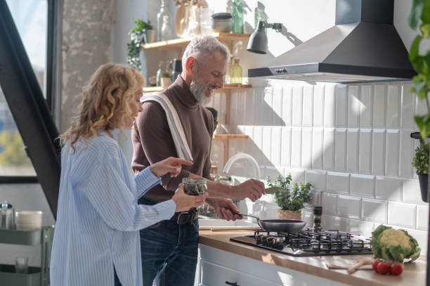 istock A mature couple in the kitchen cooking together 1445698163