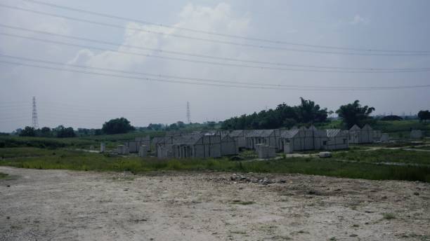 beautiful housing area at village surrounded by tree. cool and fresh air environment. unfinish housing area at village with hill and electricity tower background - unfinish imagens e fotografias de stock