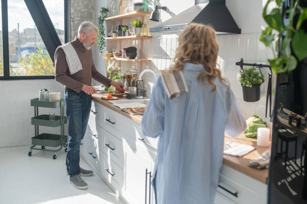 istock Gray-haired mature man cooking in the kitchen 1445698257
