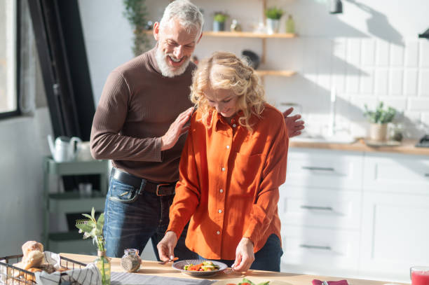 istock Couple in the kitchen preparing for a dinner 1445698314