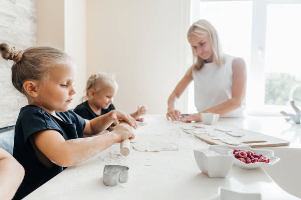 istock Children making cookies in the kitchen at home. 1445698635
