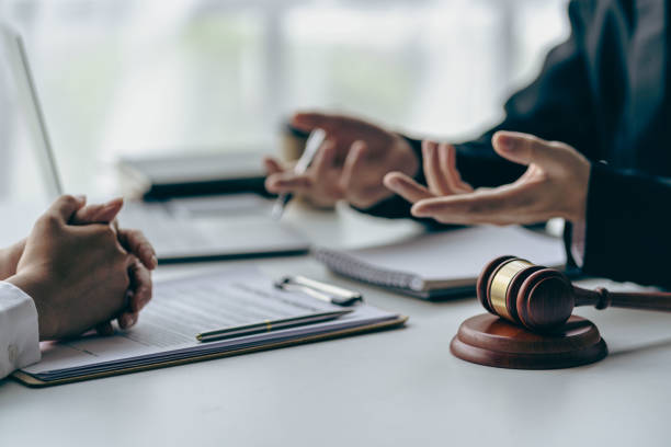 istock Office with sledgehammer in front, lawyers and clients discussing court issues or justice at meeting Law and order. The concept of courts and legislatures 1445698702