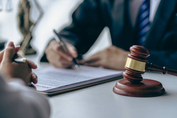 istock Office with sledgehammer in front, lawyers and clients discussing court issues or justice at meeting Law and order. The concept of courts and legislatures 1445698708