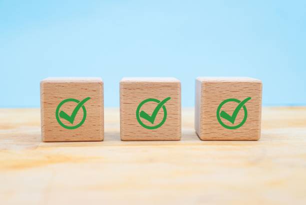 istock Checklist, Corporate regulatory and compliance, approve, Quality control management, ISO certification, service quality warranty concept. Check mark icon on wooden cube blocks on blue background 1445699783