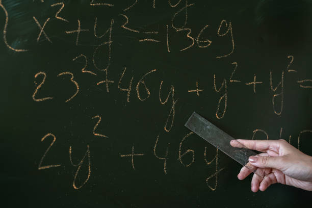 istock young teacher or student standing near blackboard and learn math lesson 1445702389