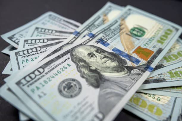 large amount of US dollars isolated on a black background. top view dollars money. business