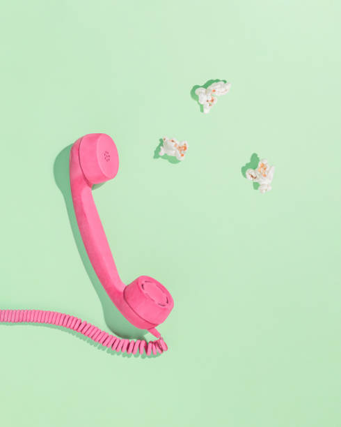 istock Minimal abstract aesthetic layout with pastel pink telephone receiver and popcorns on isolated pastel green background with shadows. Flat lay. Leisure concept. Invitation card. 1445703679