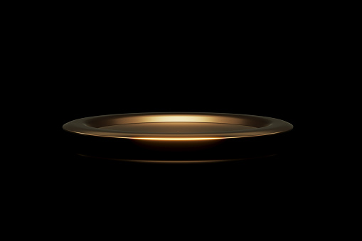 Gold platter sitting on black background. Horizontal composition with copy space.