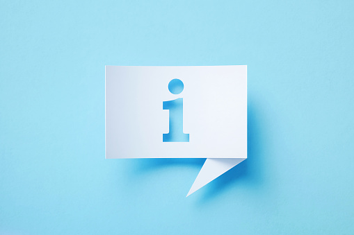 Rectangular shaped white chat bubble with cutout information desk symbol sitting on blue background. Horizontal composition with copy space.