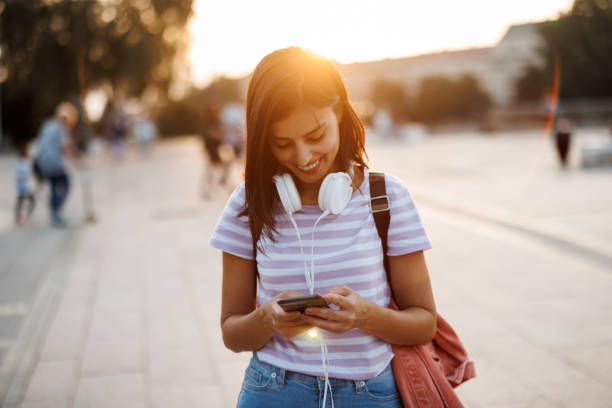 istock Young woman texting in the city 1445708246