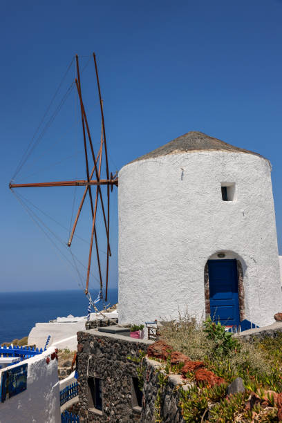 istock Traditional white windmill in Oia on Santorini. 1445708351