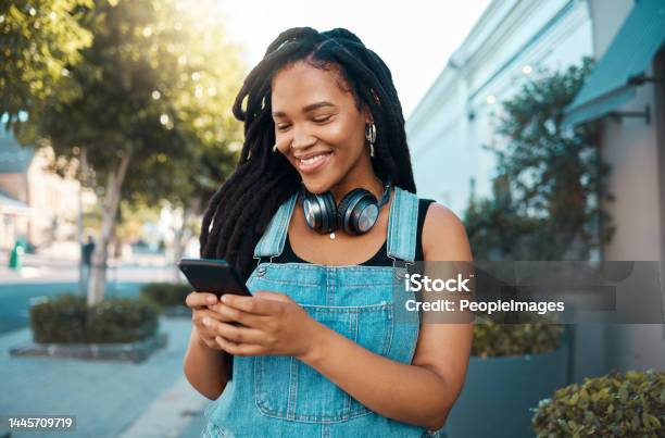 Phone Social Media And Music With A Woman In The City Using Her Mobile For Streaming Audio Or Communication Web Internet And Networking With A Young Female Reading Or Typing A Text Message Stock Photo - Download Image Now