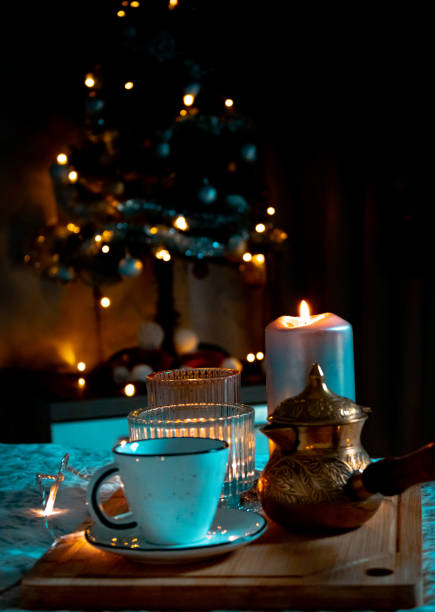 istock Cup of coffee with turk on Christmas decorations lights background 1445711710