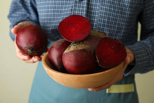 istock Woman holds fresh ripe beets, close up 1445711754