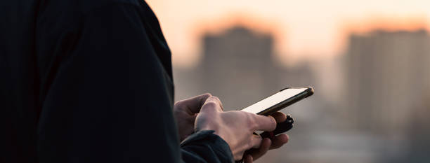 istock The guy stands with the phone 1445714066